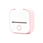 Compact pink and white portable label printer with front circular button, isolated on white
