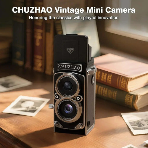 CHUZHAO vintage mini camera on a desk with books and old photos, retro photography gadget